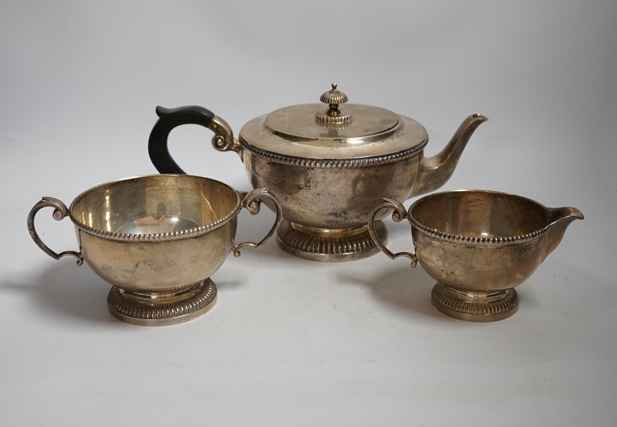 A George V three piece silver circular tea set, by James Dixon & Sons, Sheffield, 1935, gross weight 45,3oz